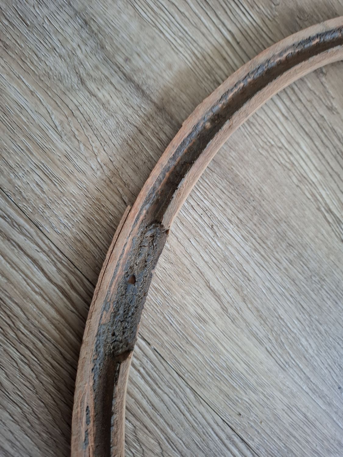 One of the two wooden half-rims, with its groove